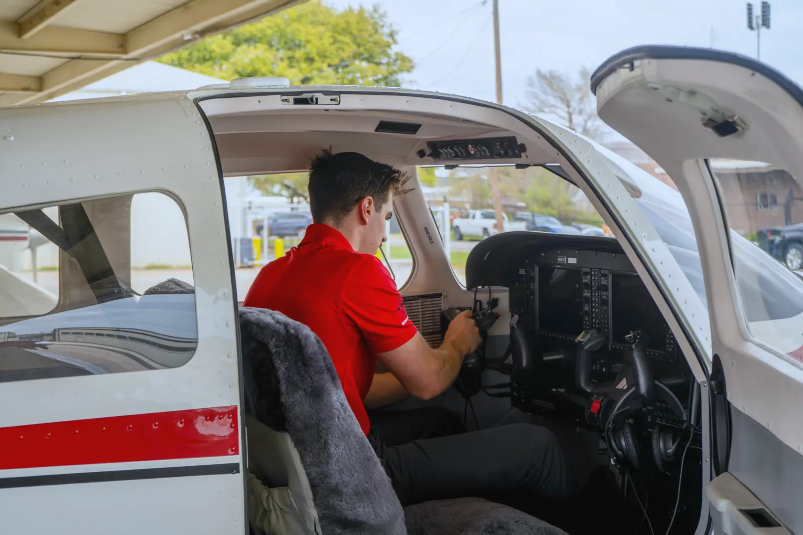 A Thrust Flight student in the left seat of a Piper Archer with the avionics lit
