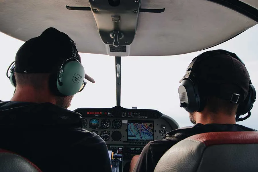 flight instructor teaching student while flying