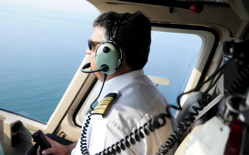 FCC license for pilots: an airline captain wearing a radio headset in the cockpit