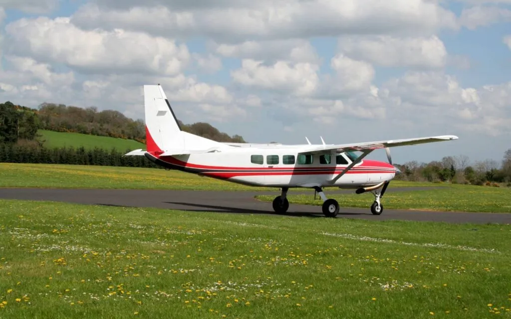 Cessna Caravan single-engine turboprop on a grass-lined taxiway