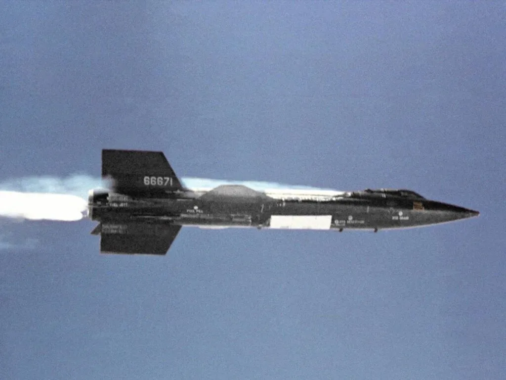 NASA X-15 rocket plane in flight with its engine firing