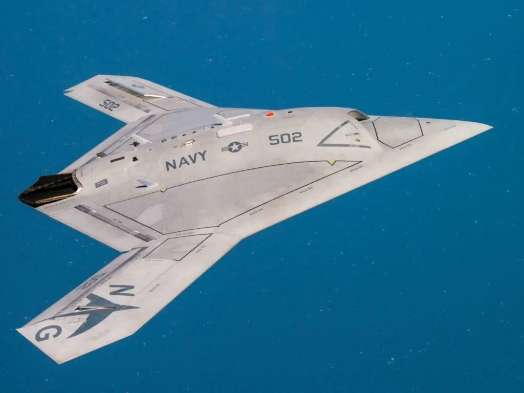 Navy X-47B unmanned stealth aircraft in flight over the ocean