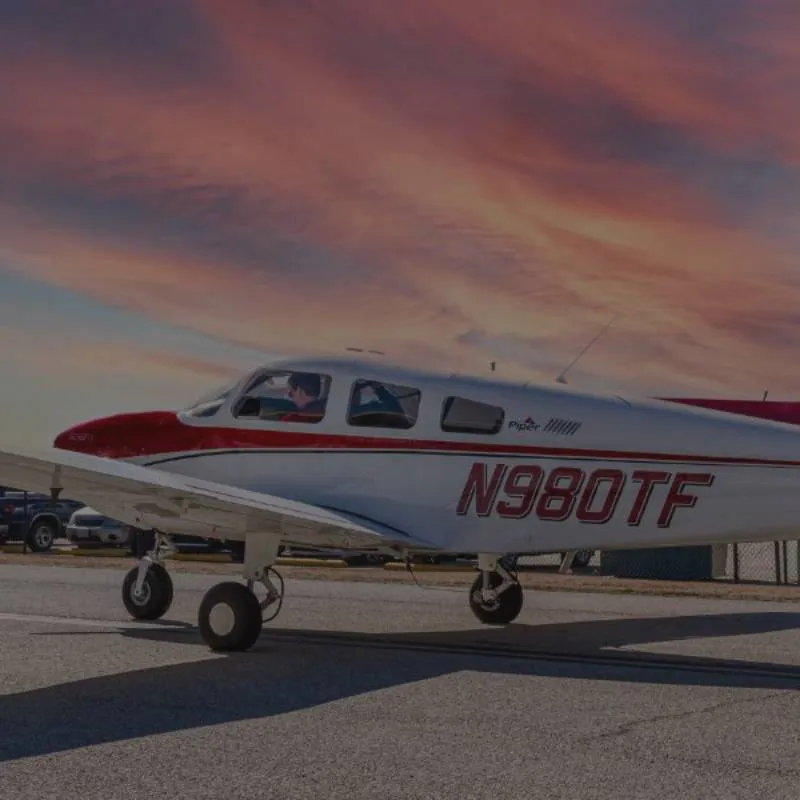 Piper-Archer-TX-Horizontal Thrust Flight Piper Archer TX on the ramp under a sunset sky